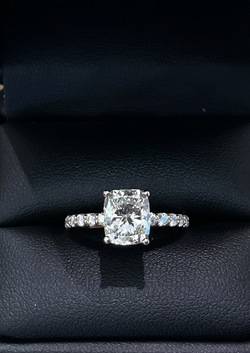 Cushion-cut diamond with pavé diamond band
